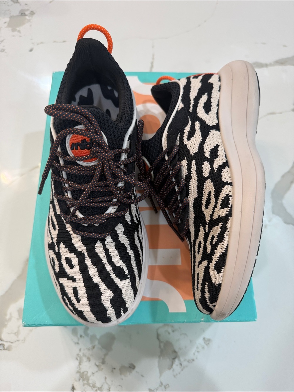 Snibbs Zebra-Pattern Knit Slip-On Sneakers in Black & Cream with Orange Accents